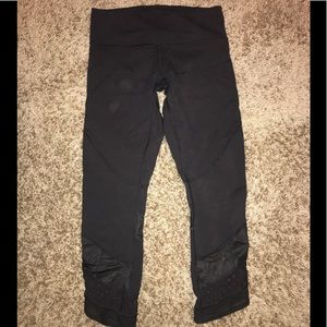Black cropped lululemon leggings with mesh detail